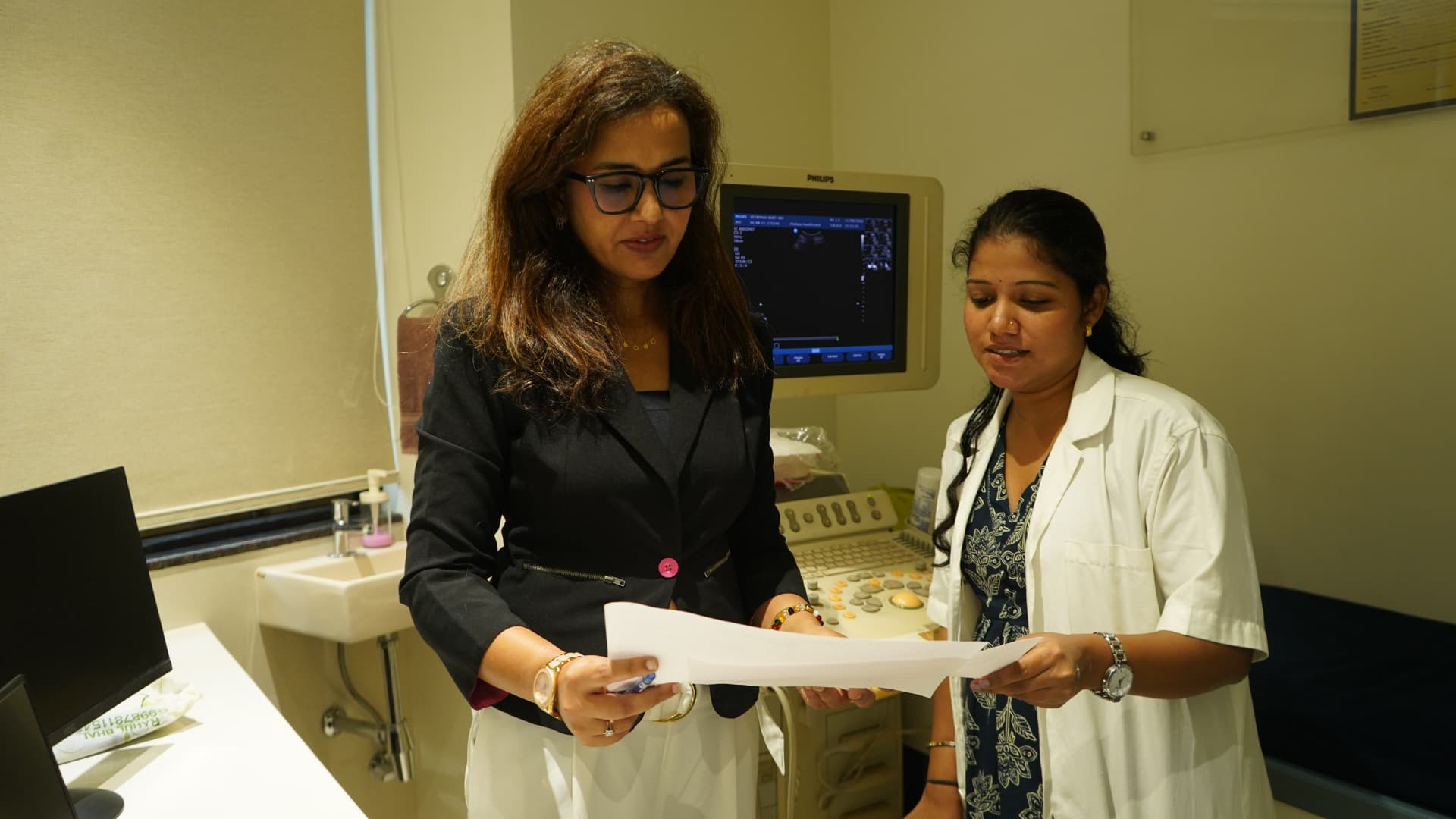 Doctor discussing a report with staff
